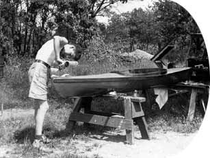 Photograph: Teenager Nelson works on a kayak.